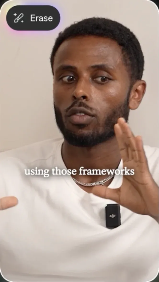 Source footage with hardcoded captions still burned in, and the Erase control available.